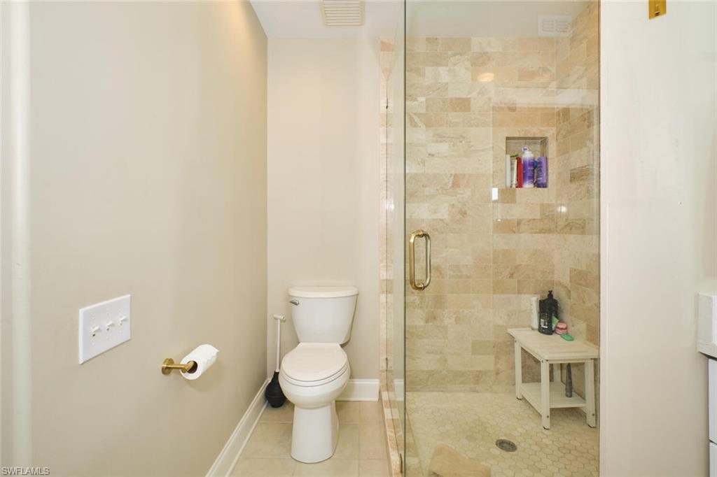 Full bathroom with a stall shower and light tile patterned floors