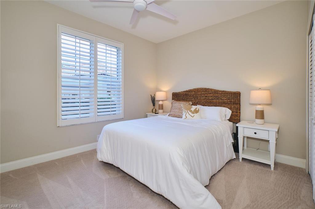 Bedroom featuring light colored carpet and ceiling fan