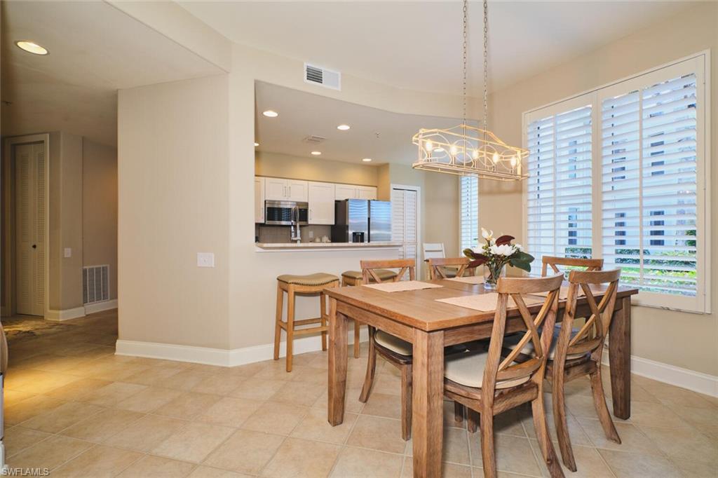Dining area with recessed lighting and light tile patterned floors