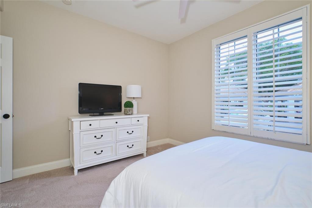 Bedroom featuring light colored carpet and ceiling fan