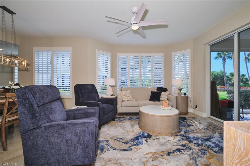 Living area featuring ceiling fan and plenty of natural light