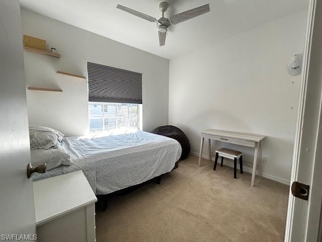 Bedroom with light colored carpet and a ceiling fan