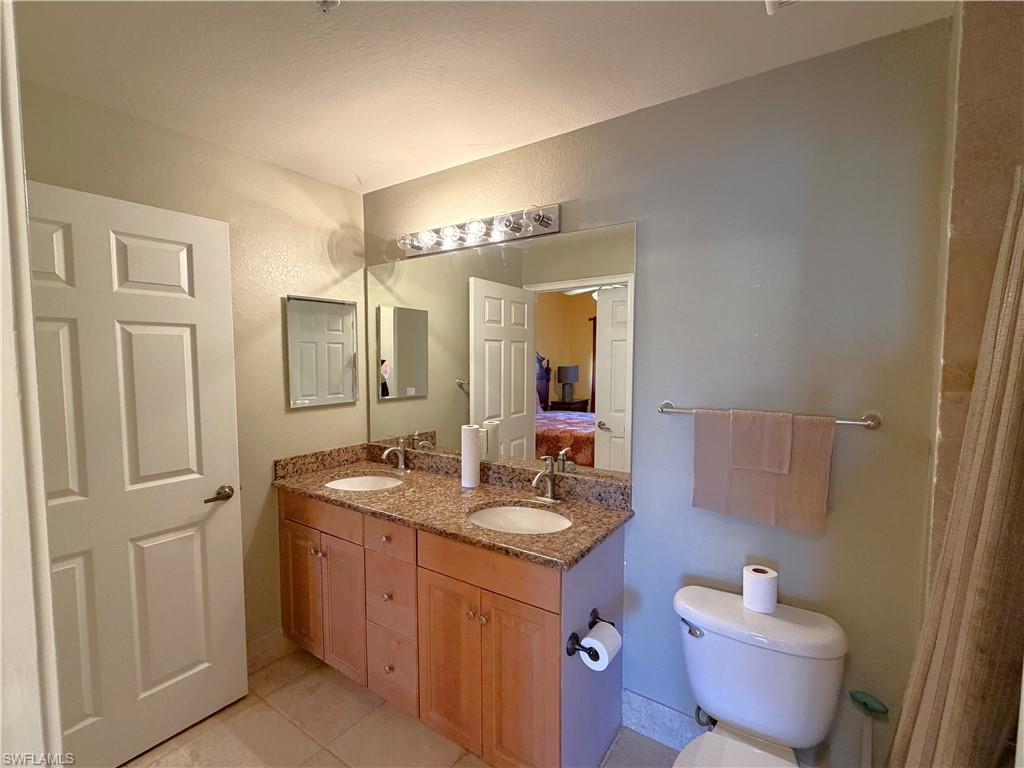 Dual sinks, granite counter, and light tile