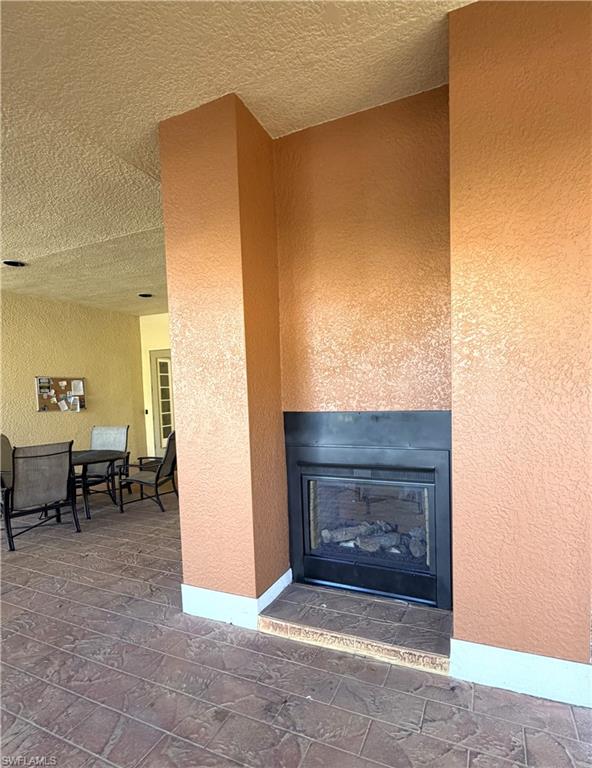 Large covered sitting area at the clubhouse with outdoor fireplace