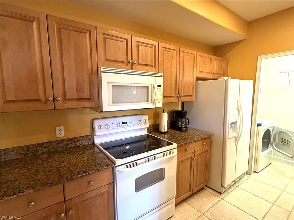 White appliances and granite countertops