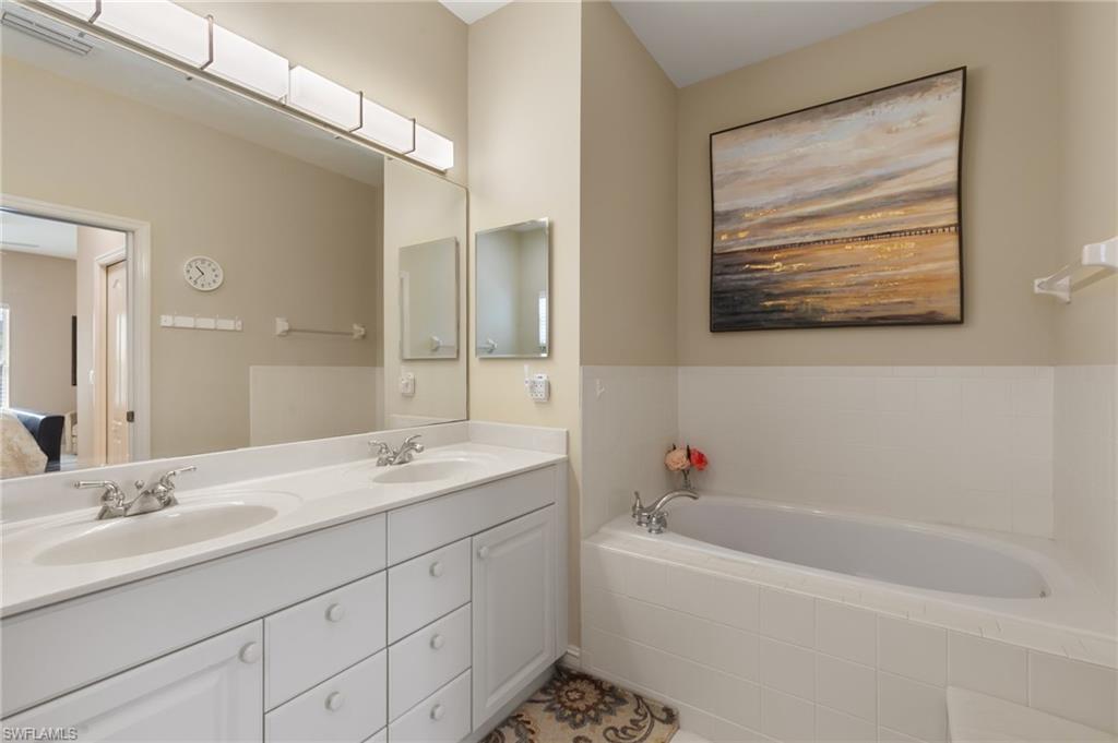 Ensuite bathroom with double vanity and a bath