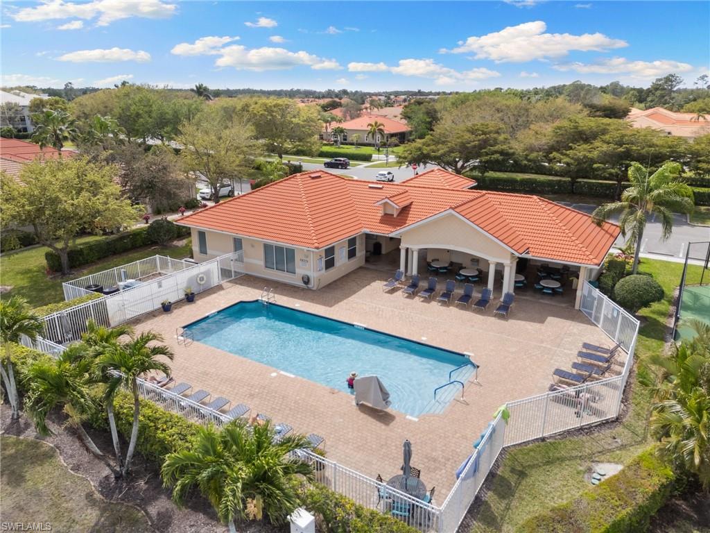 Community pool featuring a patio and a fenced backyard