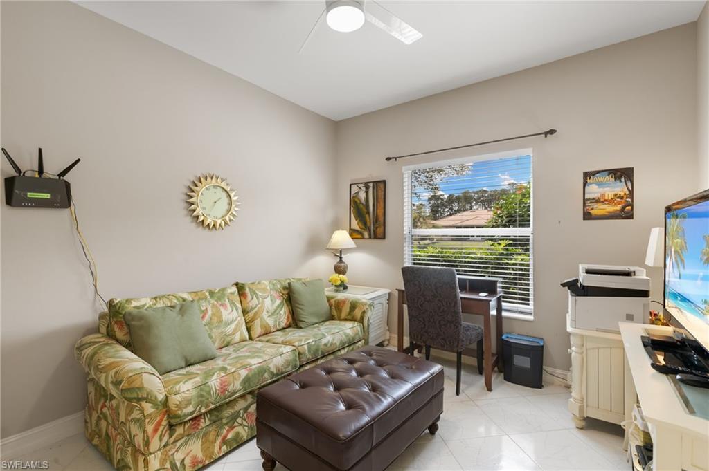 Living area featuring baseboards and a ceiling fan