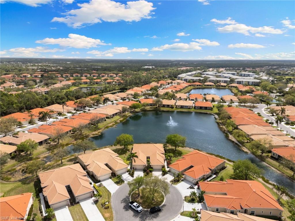 Aerial view of residential area featuring a nearby body of water
