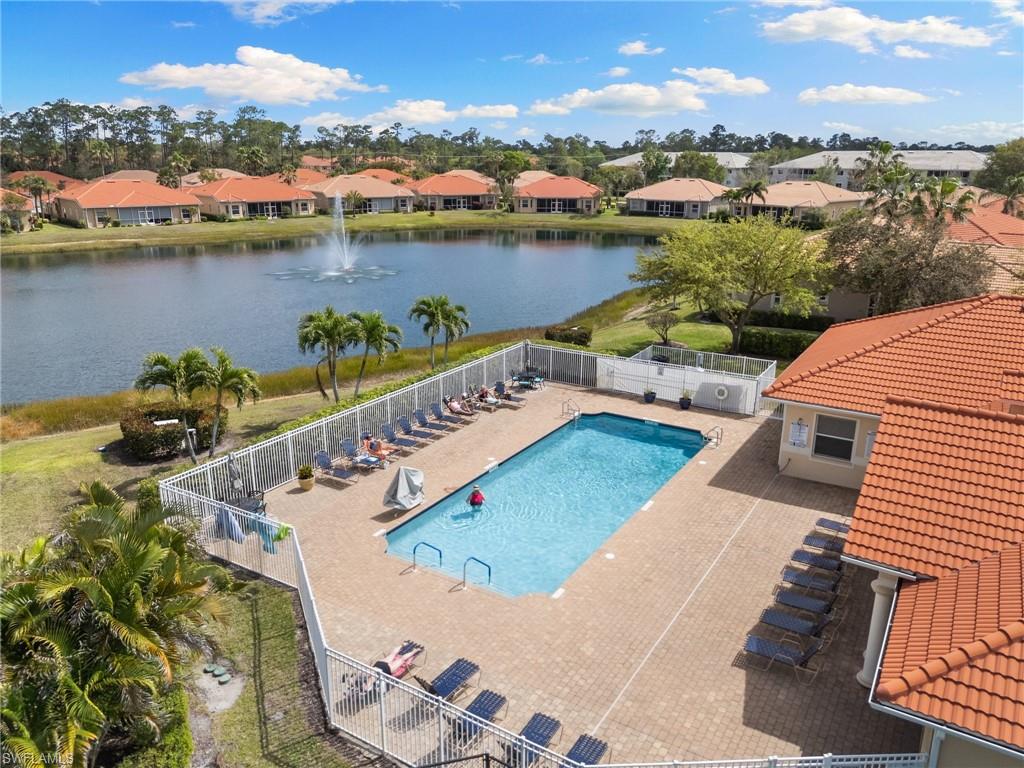 Community pool featuring a residential view, a patio area, and a water view