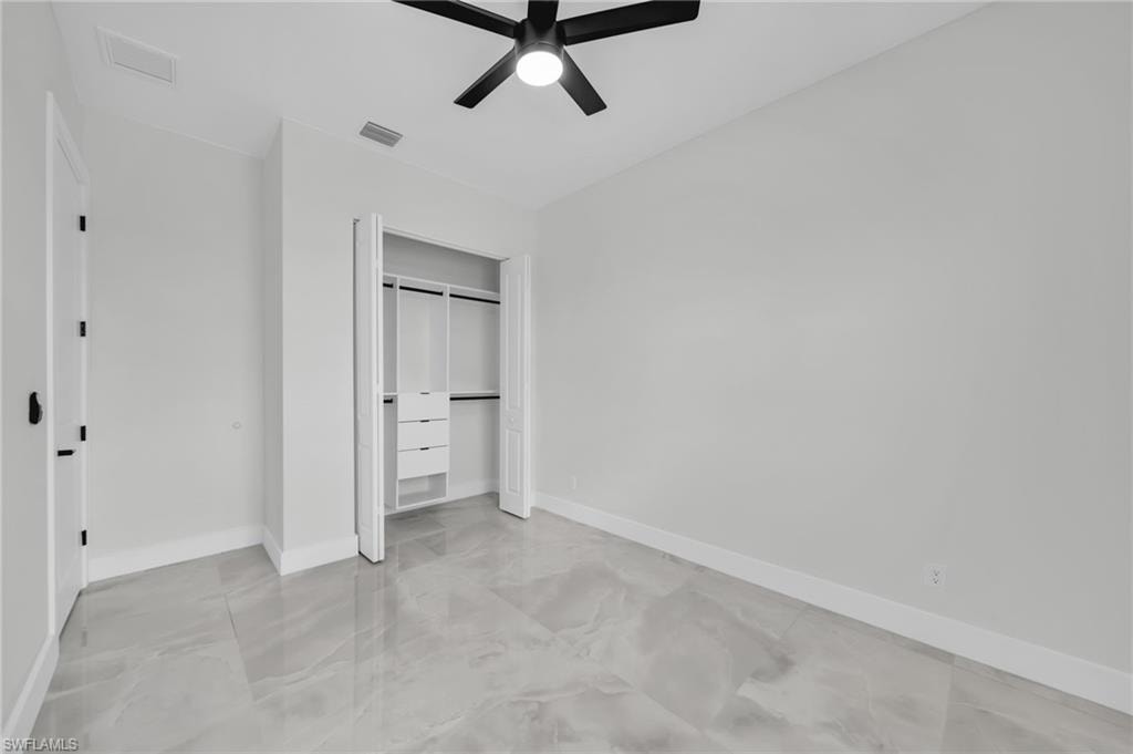 Unfurnished bedroom with a closet and ceiling fan