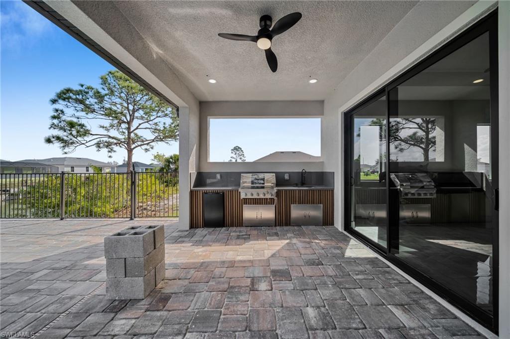 View of patio featuring ceiling fan and area for grilling