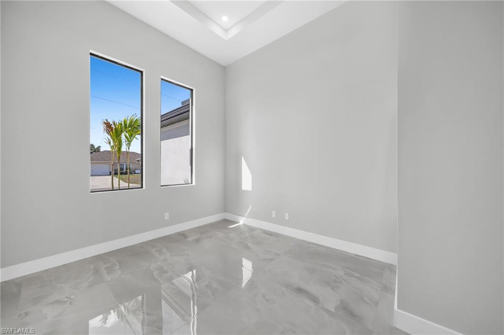 Spare room featuring baseboards and recessed lighting