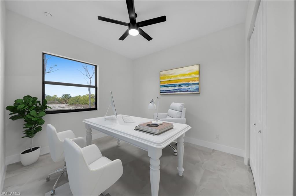 Office area with baseboards and ceiling fan