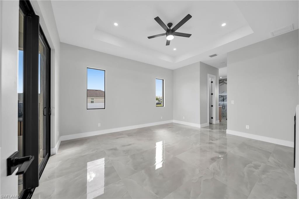 Spare room featuring ceiling fan, recessed lighting, and a raised ceiling