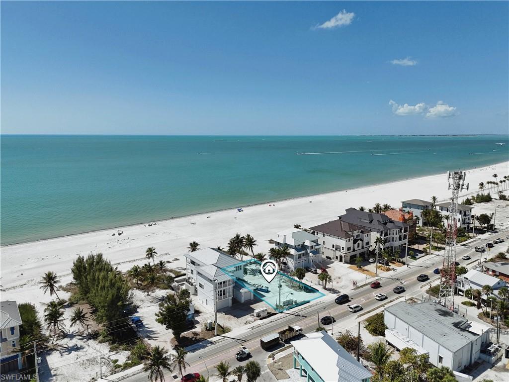 Aerial view of residential area featuring unending shoreline
