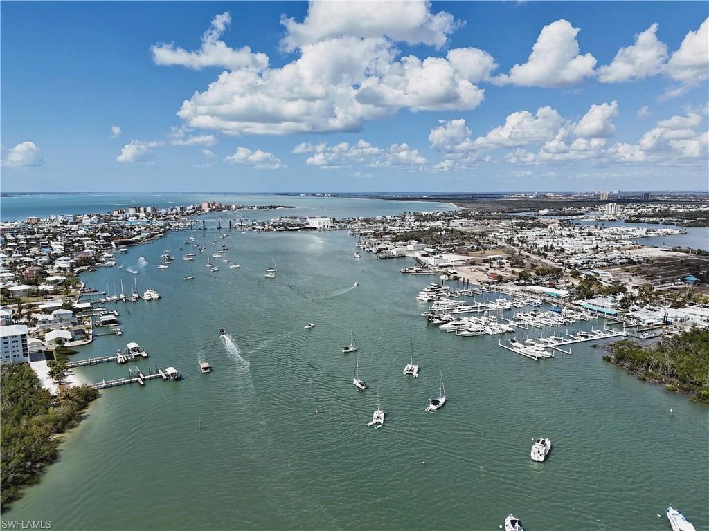 Bird's eye view of numerous boat docks and a nearby body of water