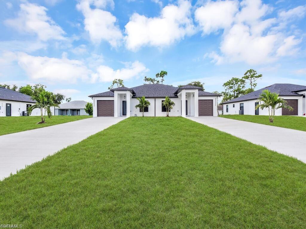 Prairie-style house with a front yard, driveway, and an attached garage