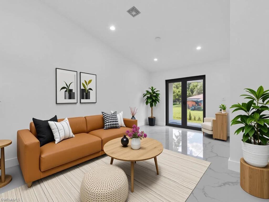 Living area featuring light marble finish flooring and recessed lighting