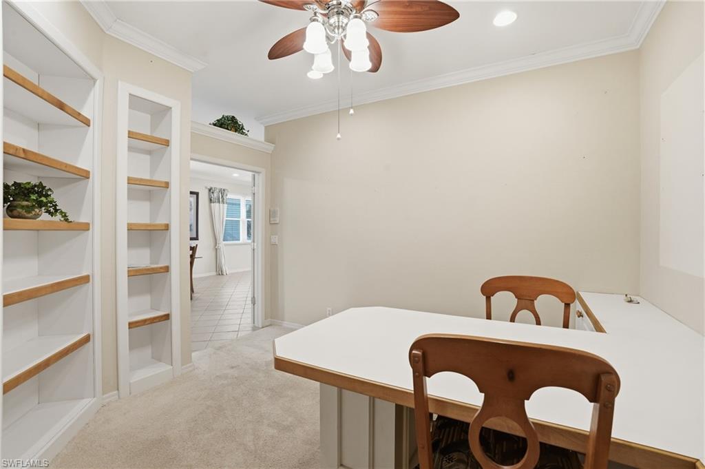 Dining room featuring light colored carpet, crown molding, built in features, a ceiling fan, and recessed lighting - Virtually Edited Image