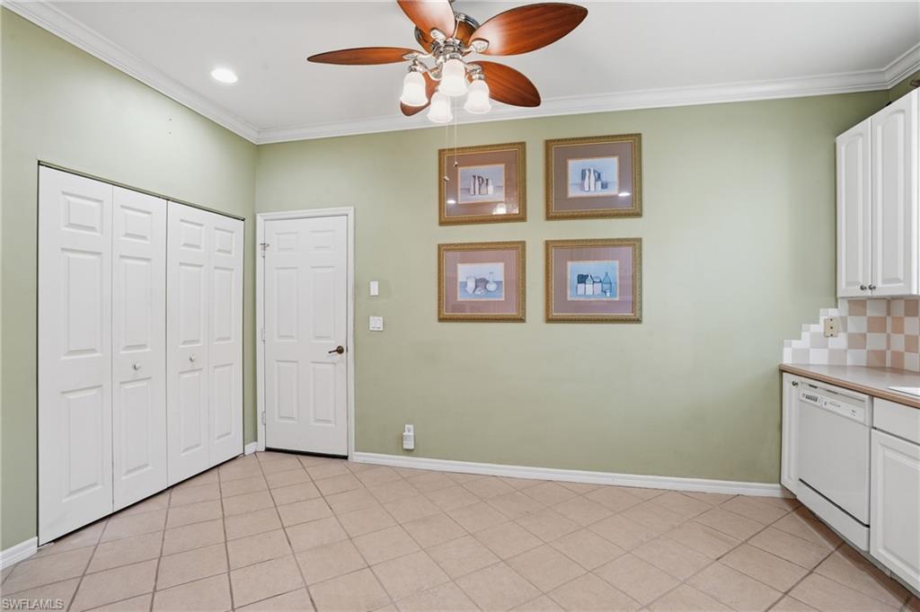 Unfurnished dining area with a ceiling fan, crown molding, and light tile patterned floors - Virtually Edited Image