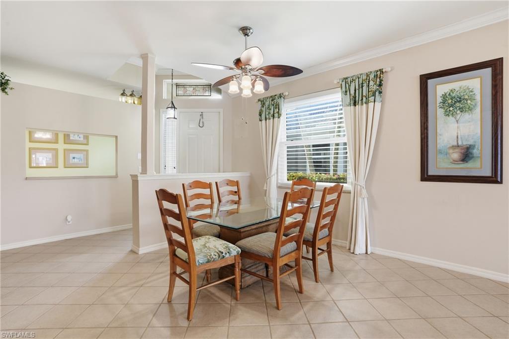 Dining area with a ceiling fan and light tile patterned flooring - Virtually Edited Image