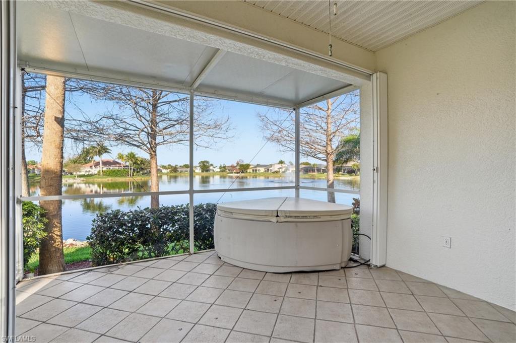 Sunroom / solarium with a water view and a residential view - Virtually Edited Image