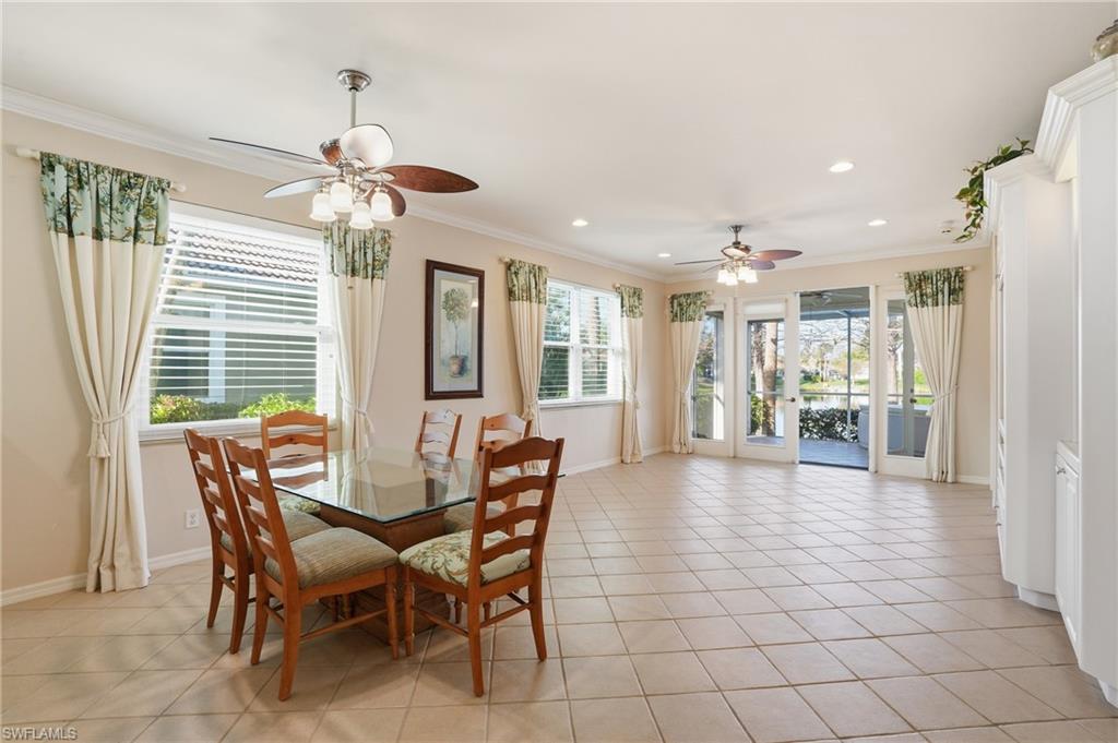 Dining area with ornamental molding, ceiling fan, recessed lighting, and light tile patterned floors - Virtually Edited Image