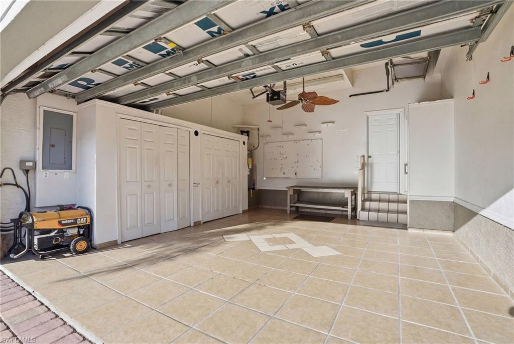 Garage featuring a ceiling fan and electric panel - Virtually Edited Image
