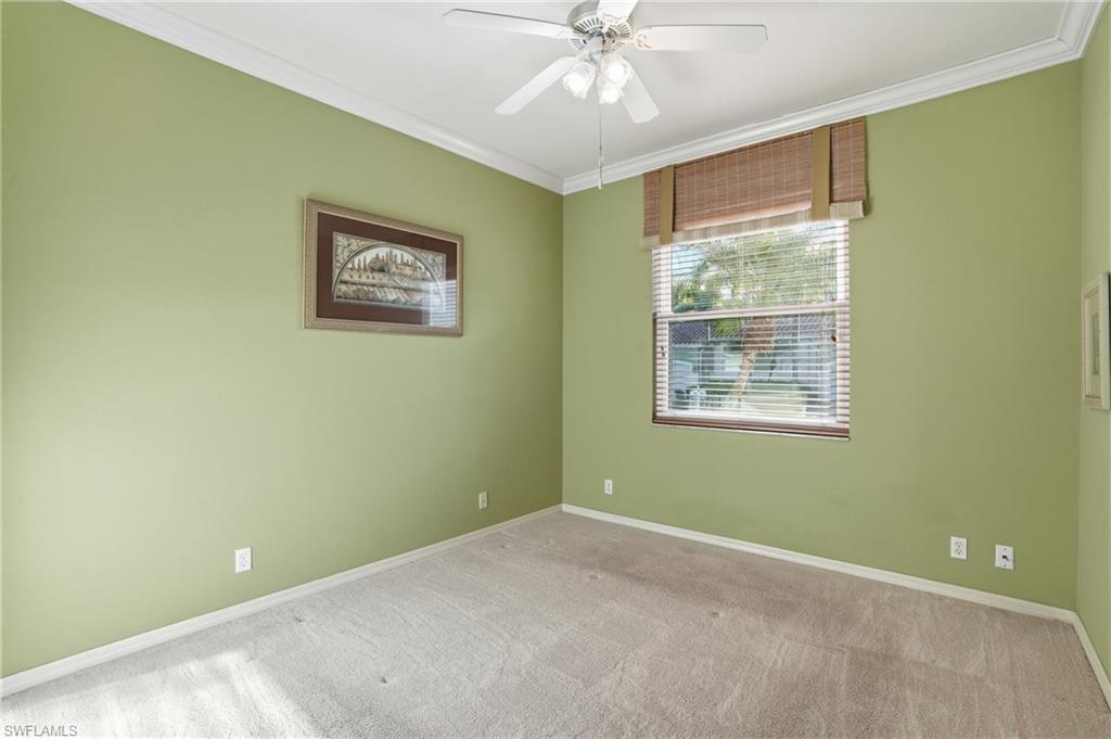 Spare room with crown molding, light carpet, and ceiling fan - Virtually Edited Image