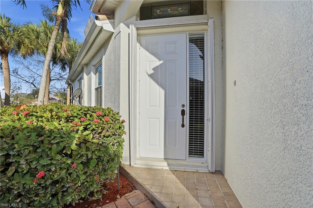 Doorway to property featuring stucco siding - Virtually Edited Image