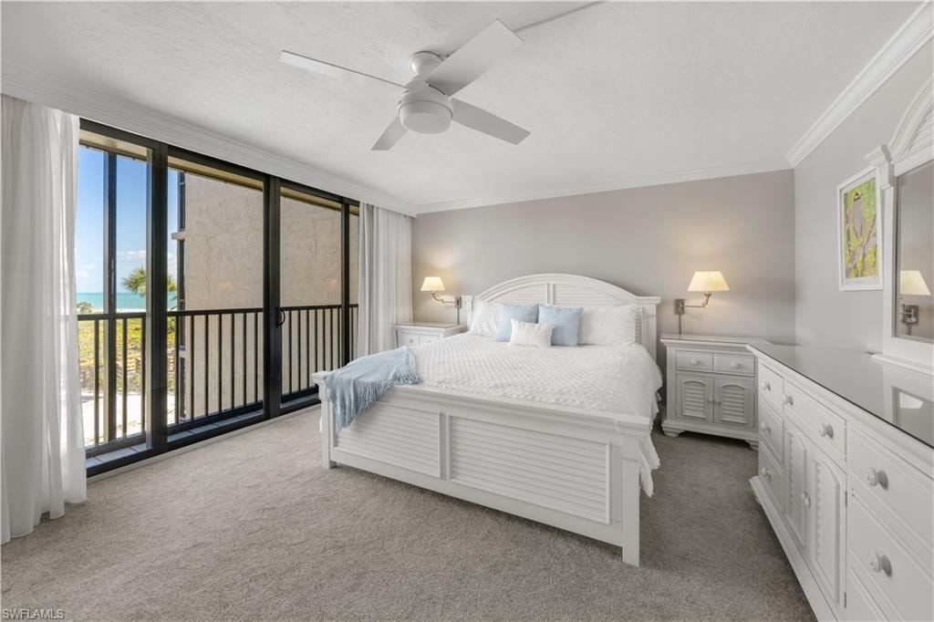Primary bedroom with white furnishings including king size bed.