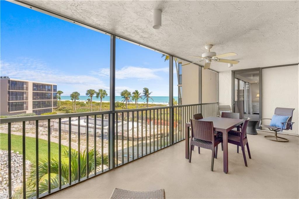 Screened lanai with view over pool and Gulf waters.