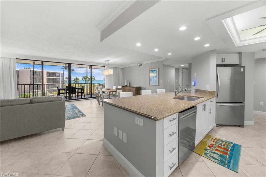 View from den area into living/dining and kitchen area.