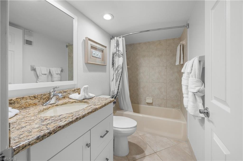 Main bathroom, white cabinets, granite counter, tub shower combo.