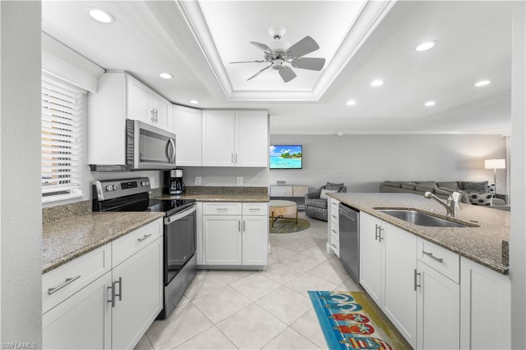 White cabinets, stainless appliances, granite counters, tile flooring.