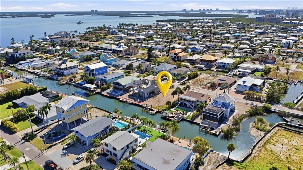 View of property location featuring a large body of water and nearby suburban area - Virtually Edited Image