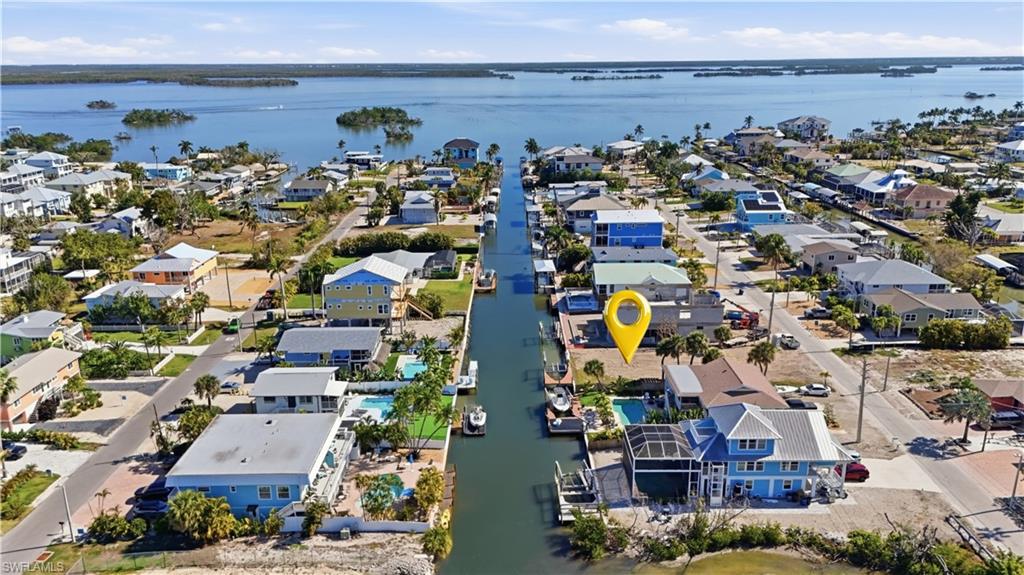Aerial perspective of suburban area with a large body of water - Virtually Edited Image