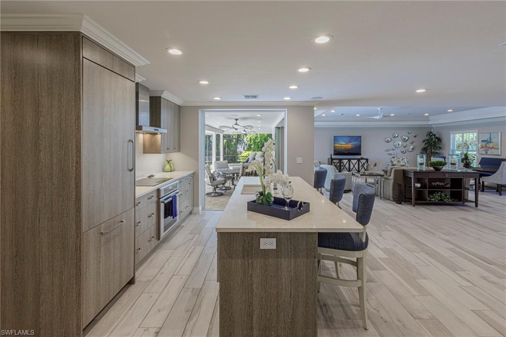Kitchen featuring a wealth of natural light, oven, light hardwood / wood-style floors, and a kitchen island