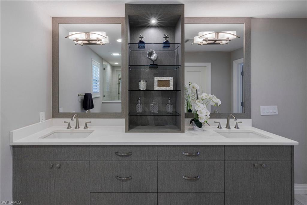 Bathroom featuring a notable chandelier and double vanity