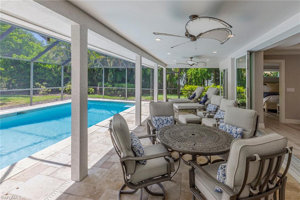View of pool featuring a patio, an outdoor hangout area, a lanai, and ceiling fan