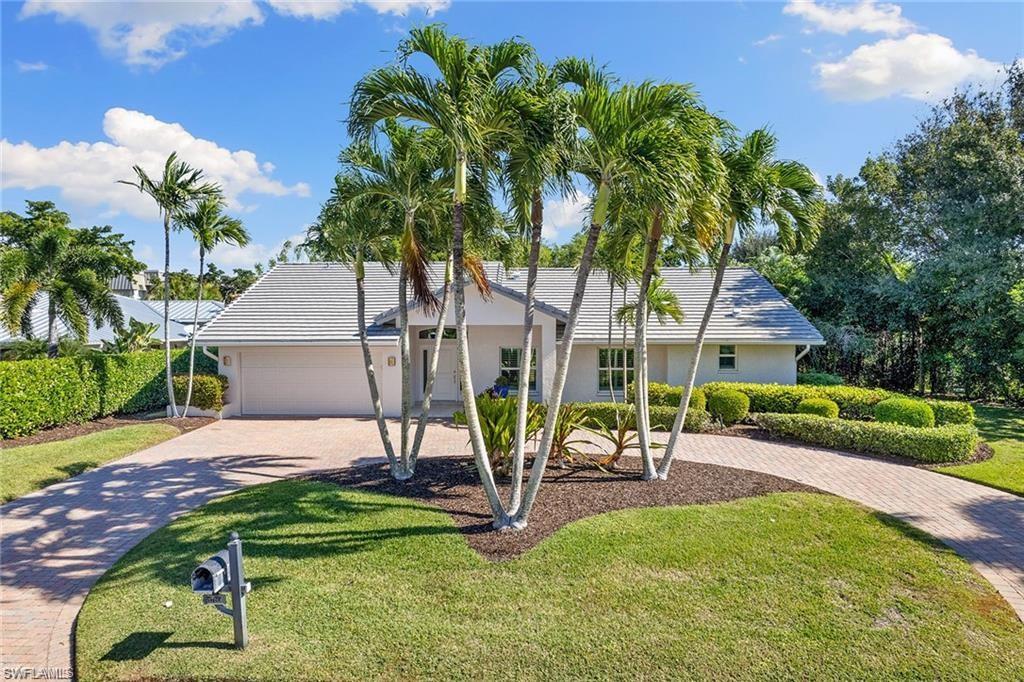 View of front of property featuring a garage and a front yard