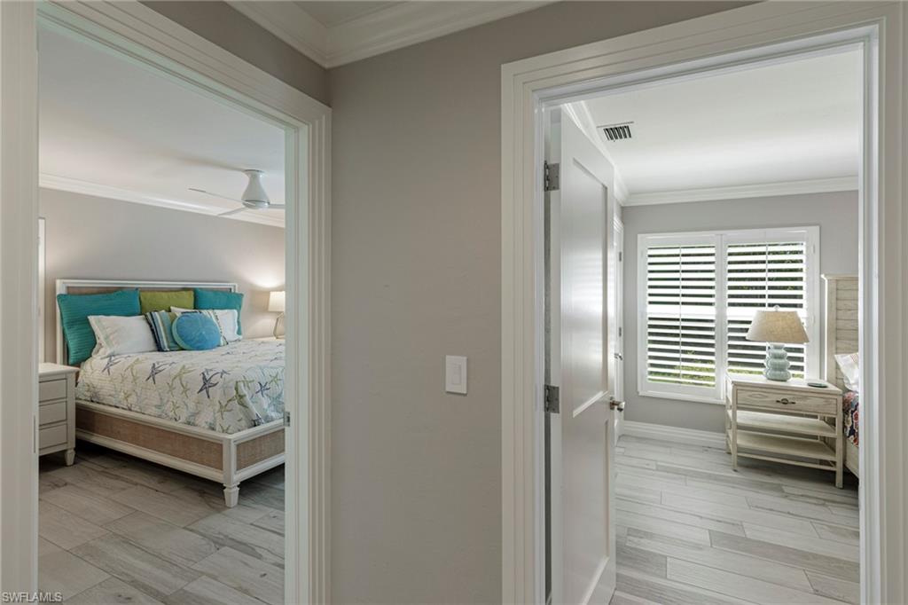 Bedroom featuring ceiling fan, ornamental molding, and light wood-type flooring