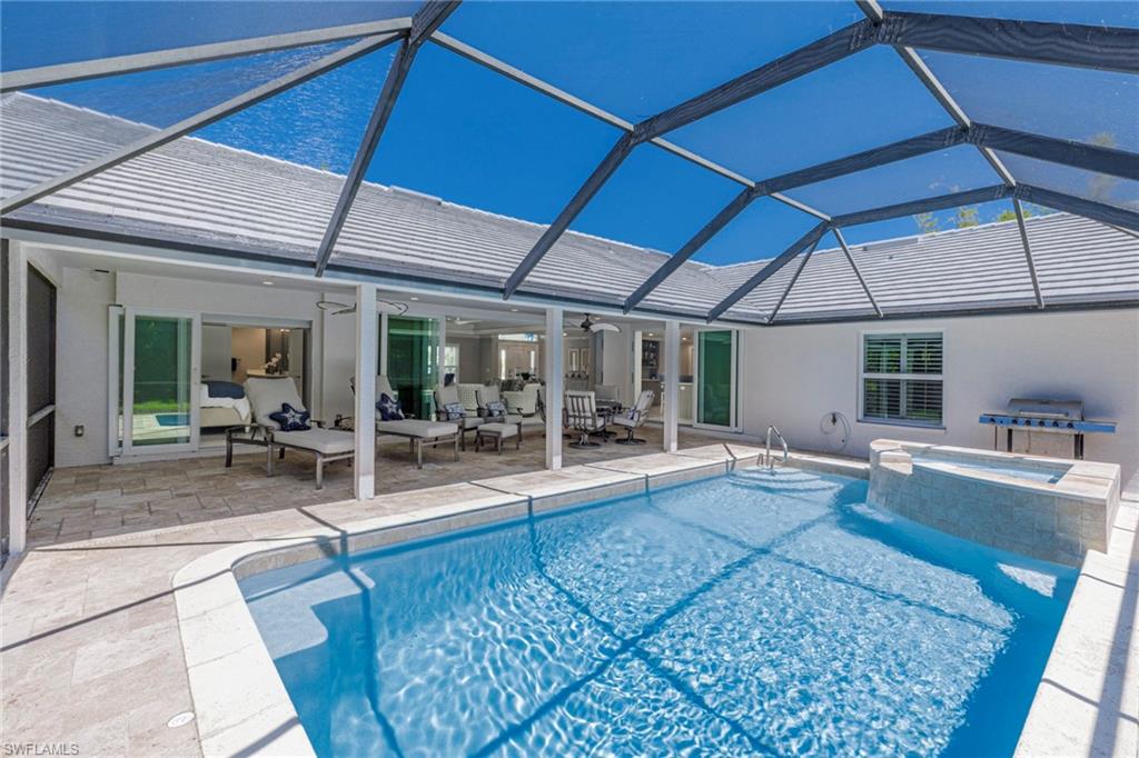 View of swimming pool featuring a patio area, an outdoor hangout area, a lanai, and ceiling fan