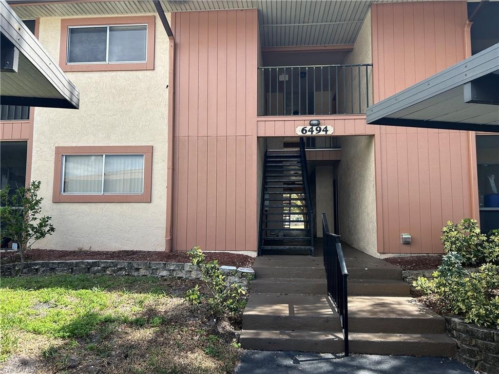 Property entrance featuring stucco siding