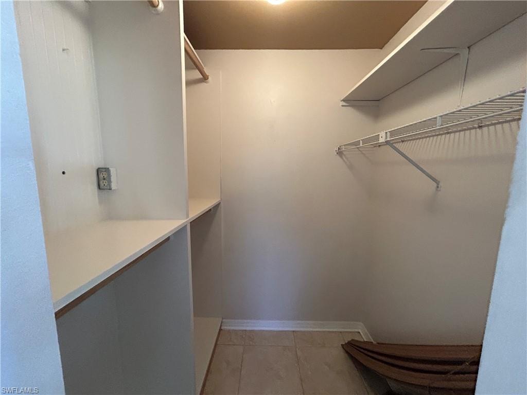 Walk in closet featuring light tile patterned flooring