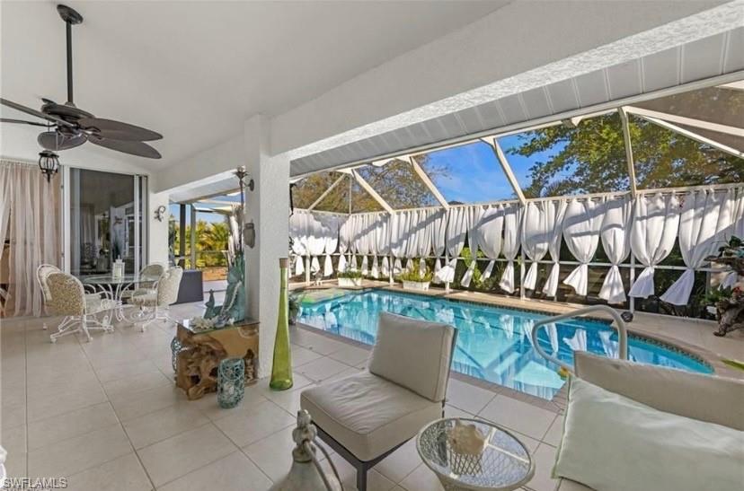 Outdoor pool featuring a lanai, a sunroom, a patio, and outdoor dining space