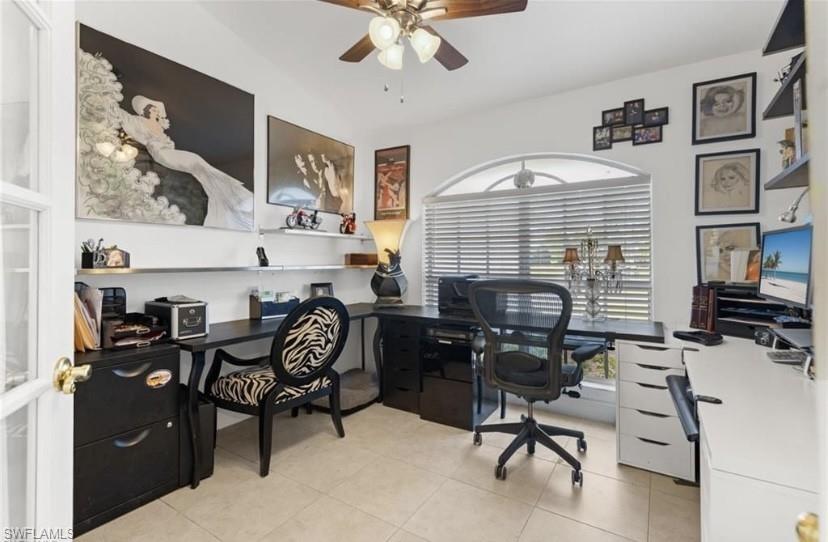 Office featuring a ceiling fan and light tile patterned flooring