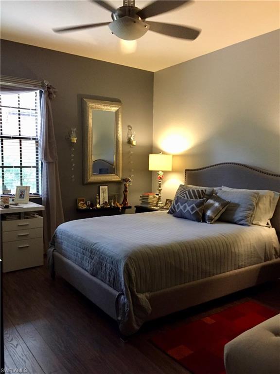 Large guest room with queen bed, office desk and love seat for reading with large walk in closet