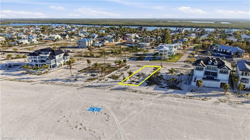 Aerial view of residential area featuring property parcel outlined - Virtually Edited Image